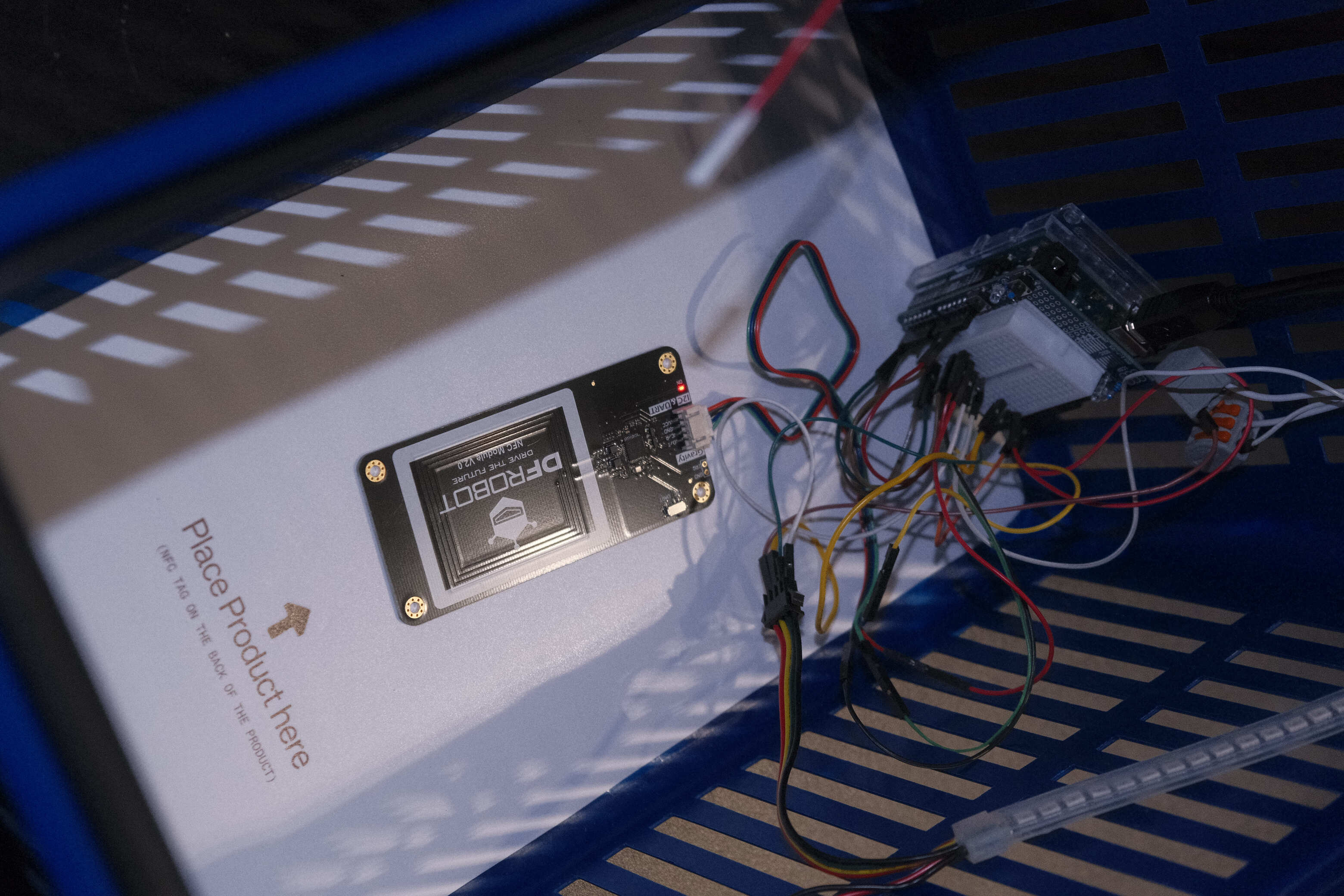 Close-up of the prototype basket showing the sensor and product-tag setup